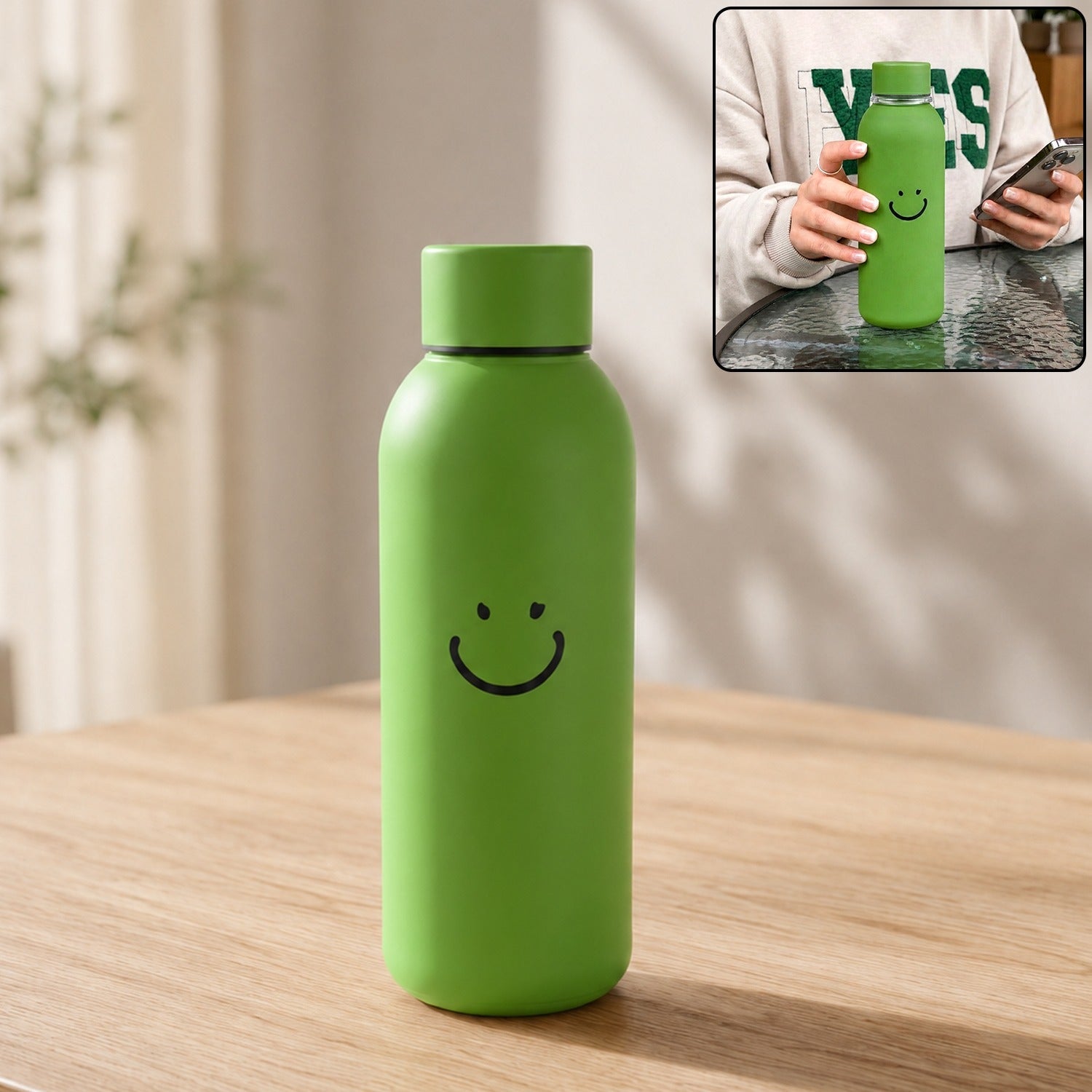 Green smiley-face travel water bottle with silicone sleeve and rounded cap