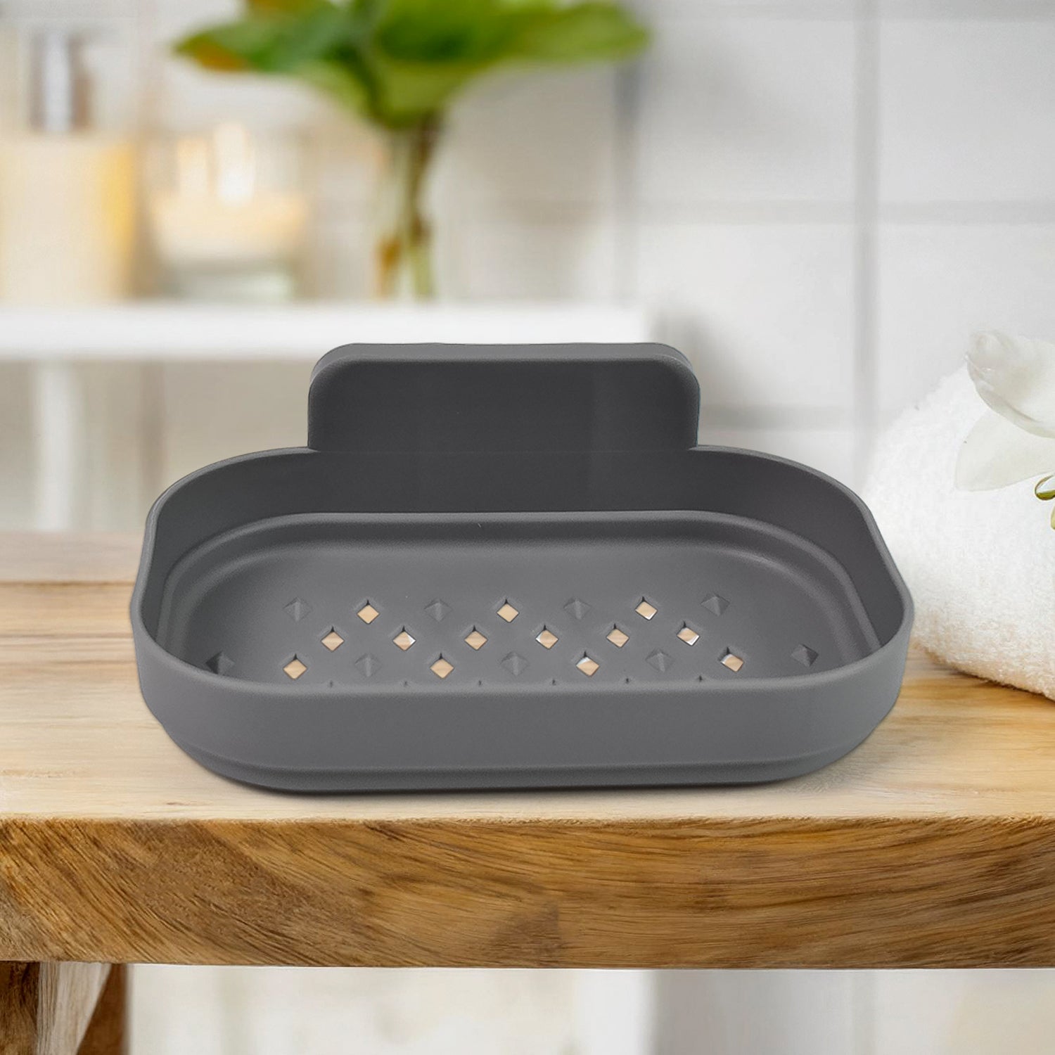 Charcoal gray soap dish with vented drainage holes and raised rear guard