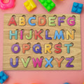 Wooden ABC Puzzle board with colourful letters and shapes for early learning.