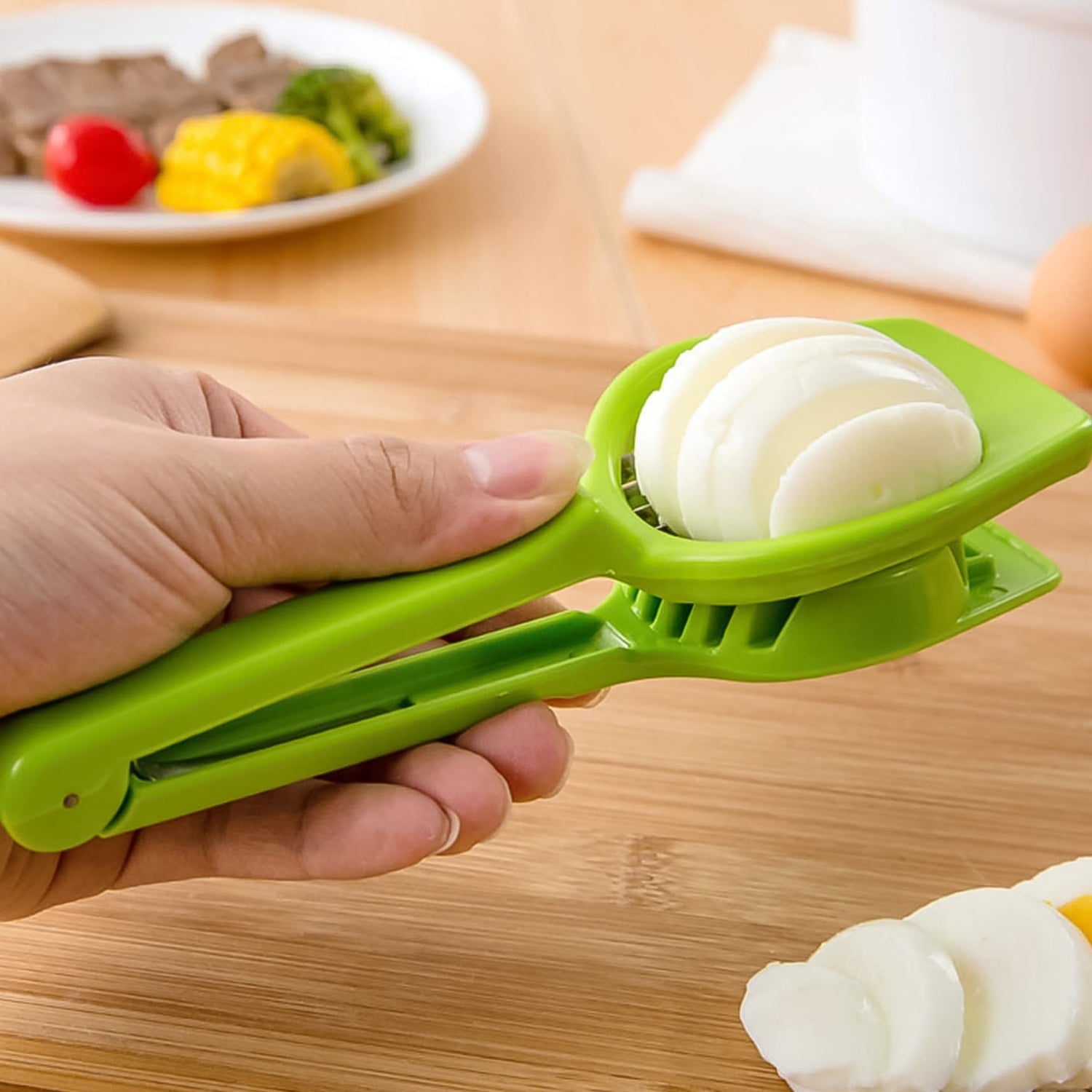 Green onion slicer tool with steel blade, cutting half onion into slices