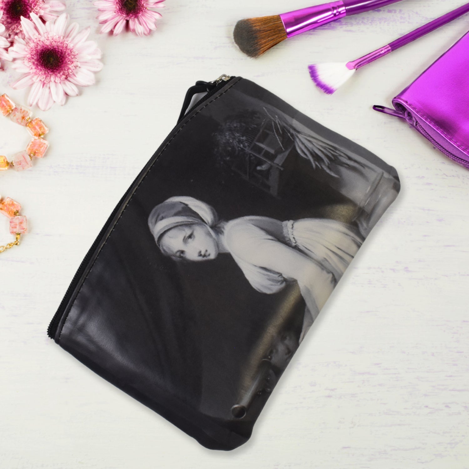 Black rectangular zip pouch with monochrome woman print, flat bottom