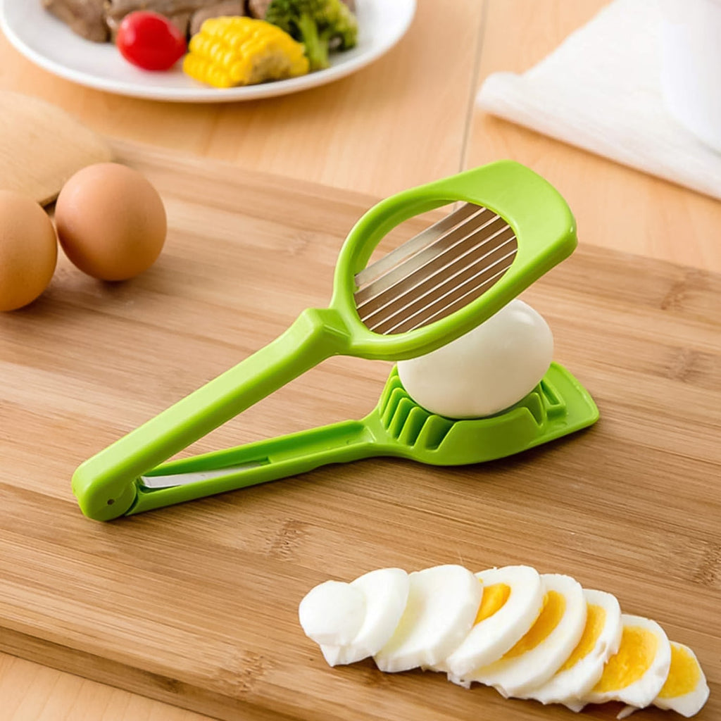 Green vegetable slicer with steel blade, onion slices on wooden cutting board