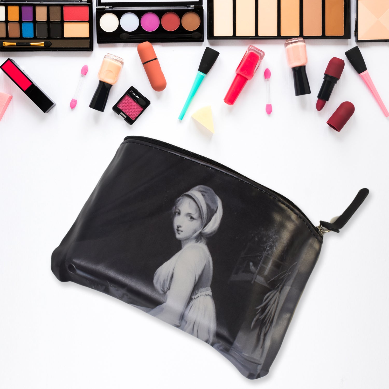 Black cosmetic pouch with monochrome woman print, zipper top and tassel pull