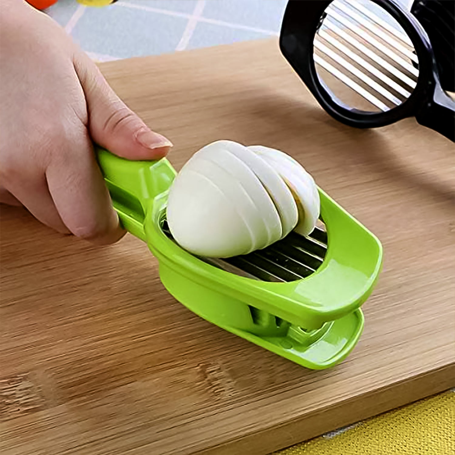 Green onion slicer with steel blade, hand pressing onion into stacked slices