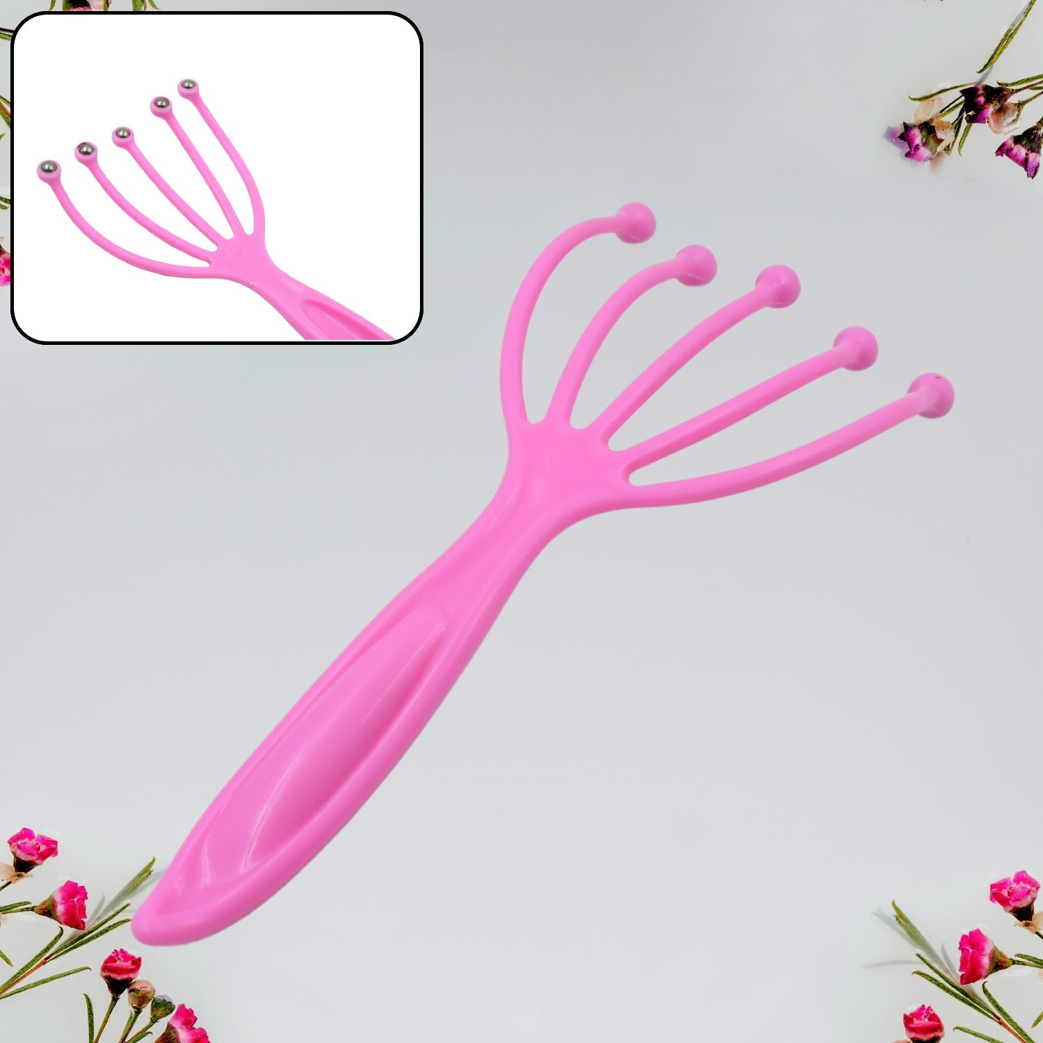 Pink scalp massager tool angled view, five prongs with round bead tips