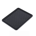 Black anti-skid mat securely holding a phone, keys, and sunglasses on a car dashboard.