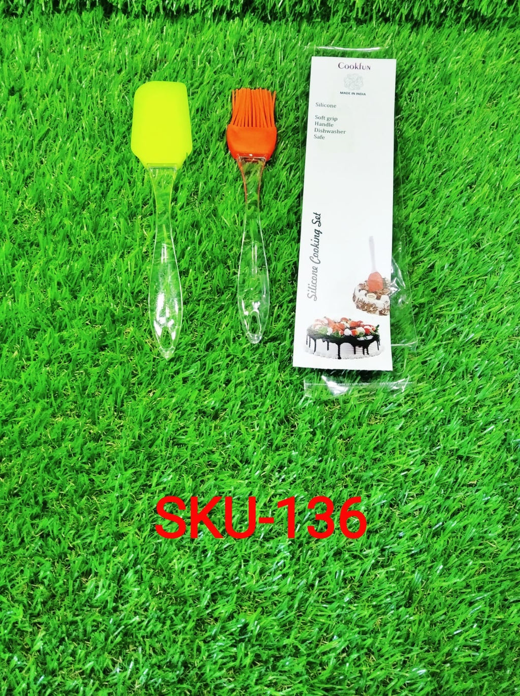 Silicone pastry brush set packaging with two brush heads on green grass background