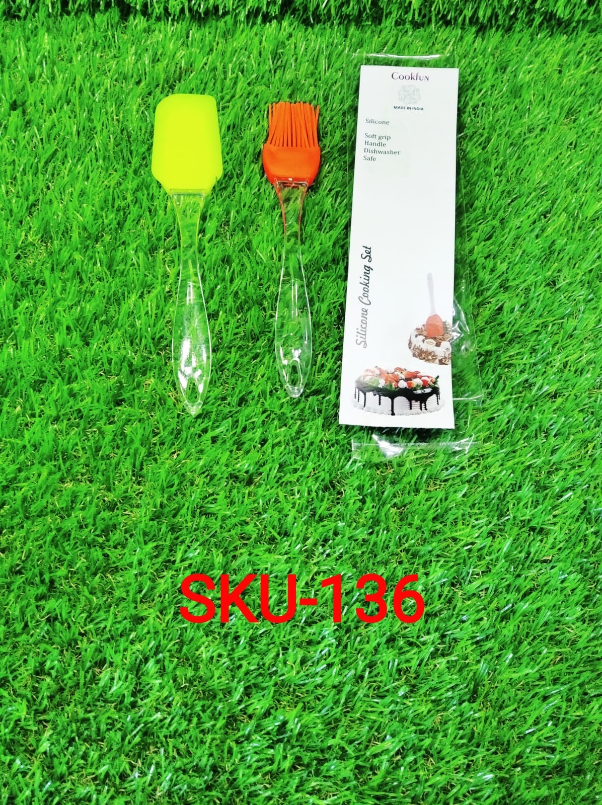 Silicone pastry brush set packaging with two brush heads on green grass background