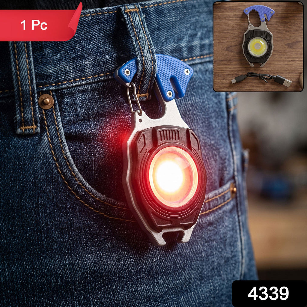 Compact red keychain mini flashlight with glowing LED, attached to blue denim jeans
