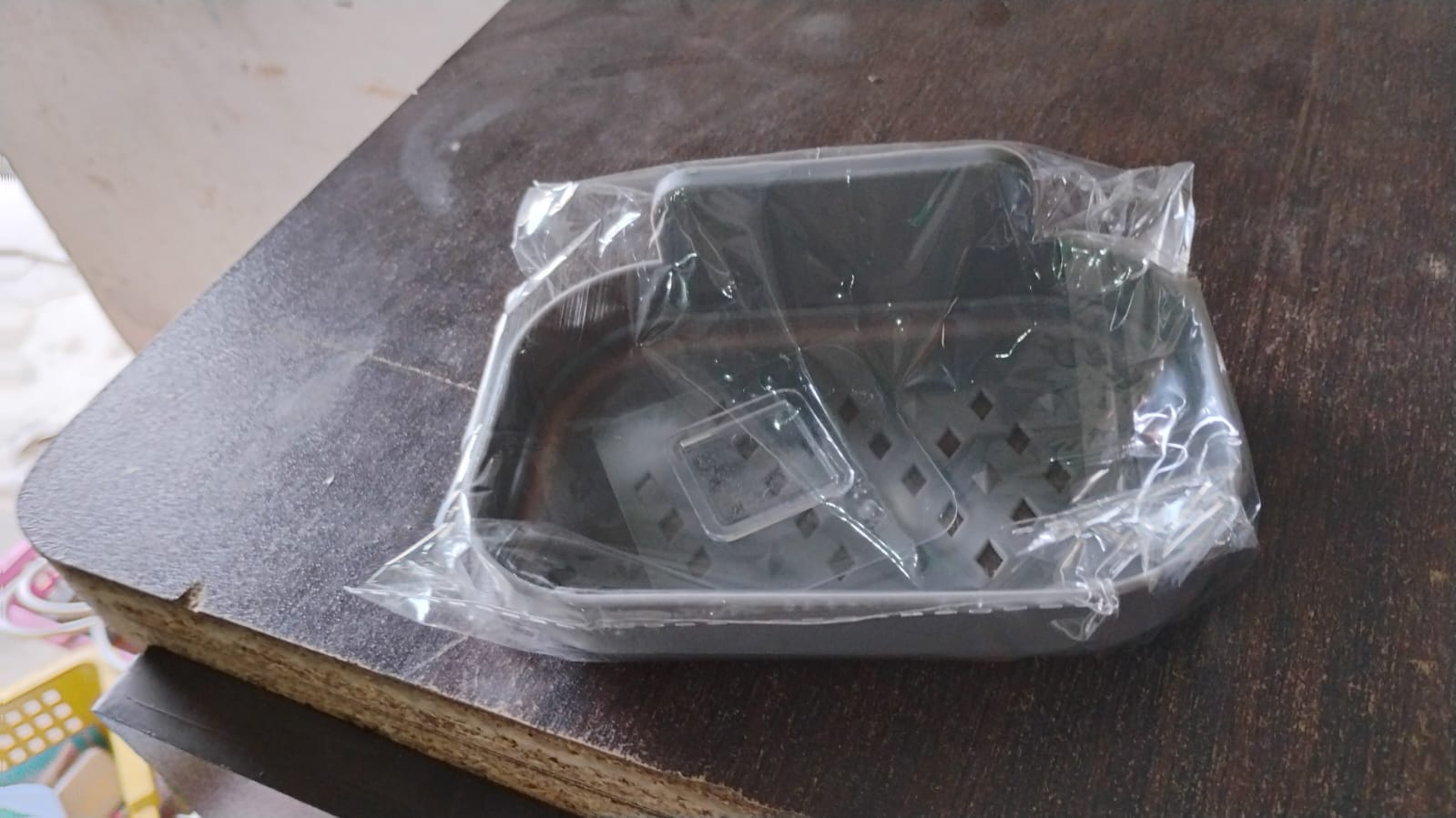 Soap dish holder in clear plastic bag, dark gray tray with drainage holes