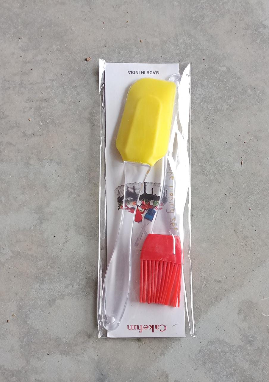 Packaged silicone pastry brush and spatula set, yellow and red tools in plastic wrap