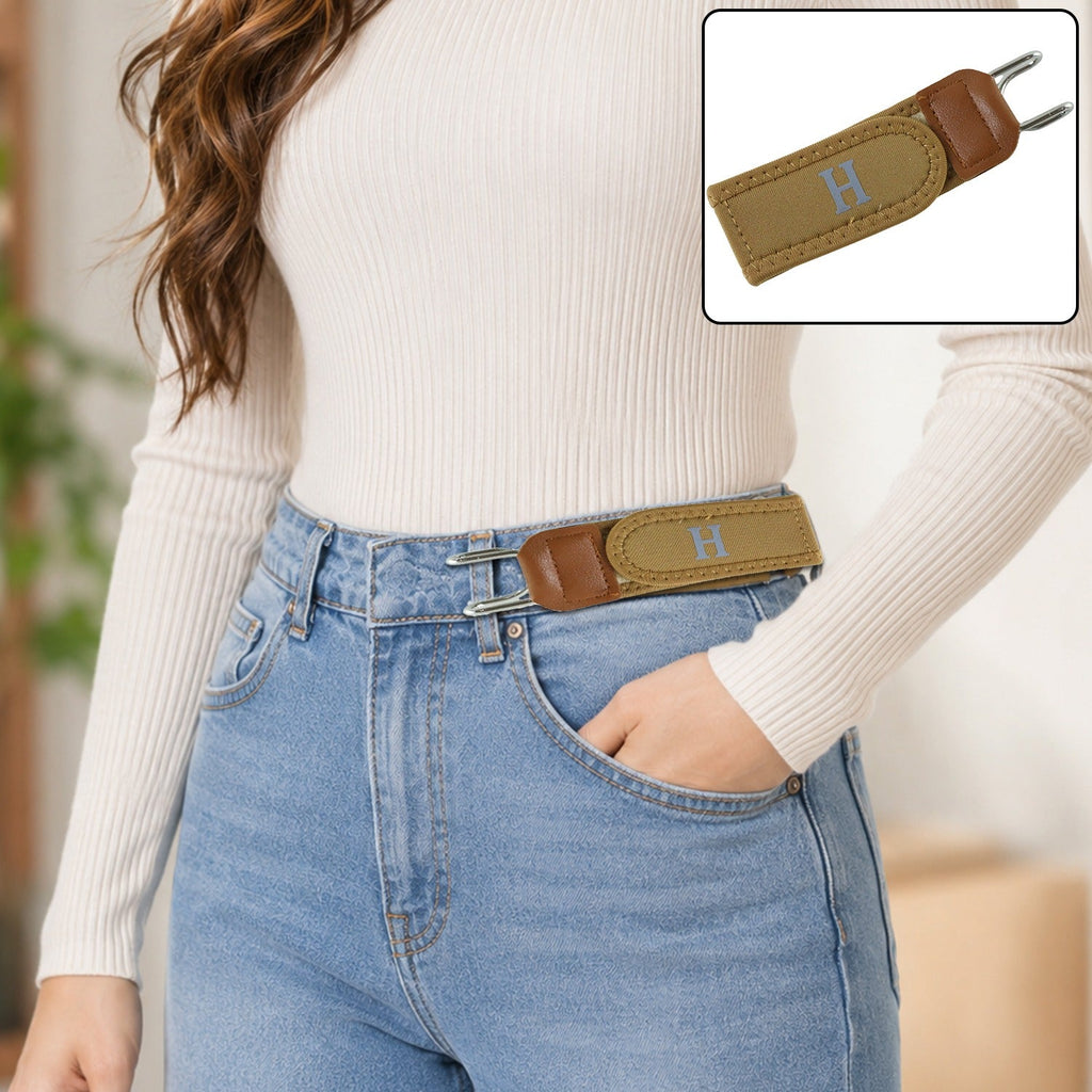 Women's tan stretch waist belt with sliding buckle on light blue jeans, no visible elastic
