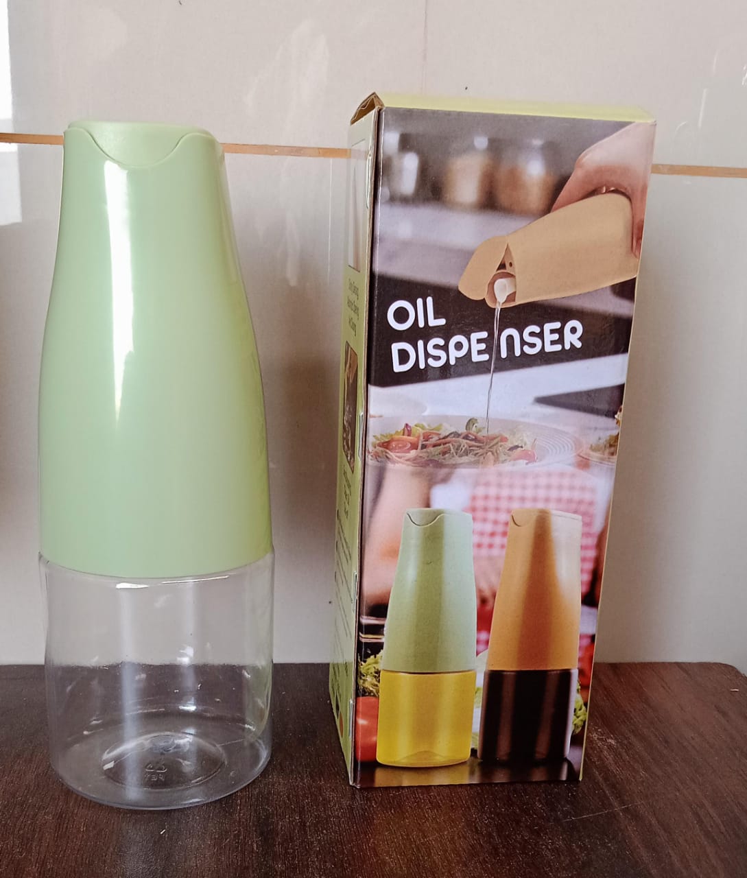 Light green and clear squeeze sauce dispenser bottle standing on a countertop