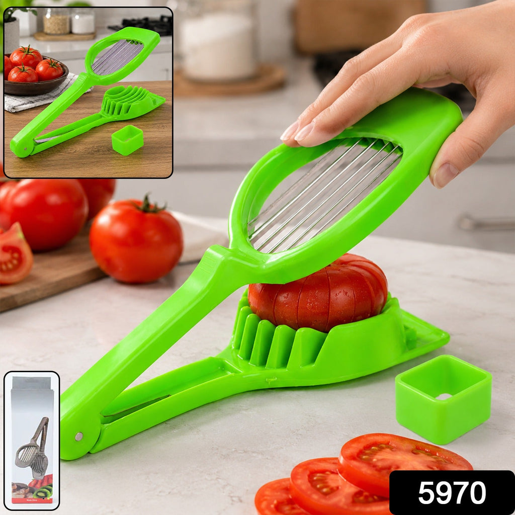 Green tomato slicer with steel blade, slicing tomatoes with hand grip on countertop