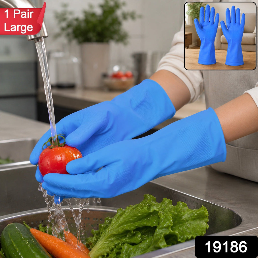 Blue rubber cleaning gloves worn with water and vegetables in a kitchen sink