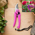 Pink garden pruning scissors with stainless steel blades and black wrist strap