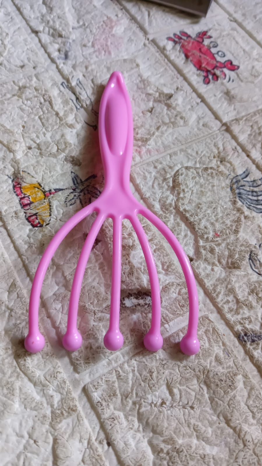 Pink scalp massager tool full view with five prongs and round bead tips