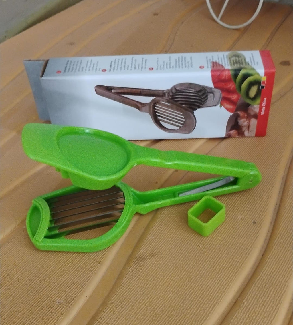 Green fruit slicer on countertop with product package box in background