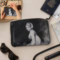 Black zippered travel pouch with monochrome woman print, round grommet detail