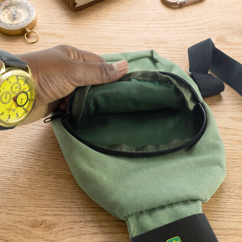 Green canvas sling crossbody bag open top with inner lining and black zipper trim