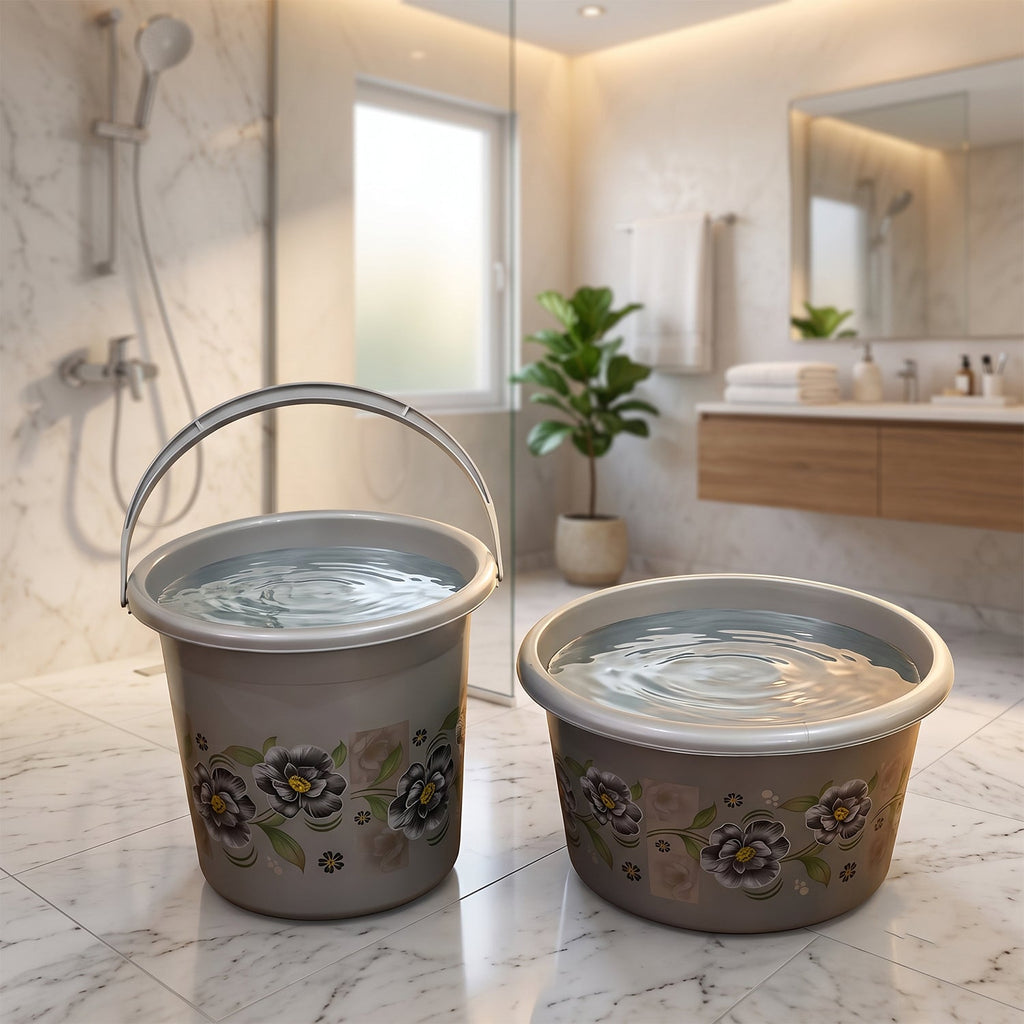 Two gray floral plastic buckets with handles for bathroom storage