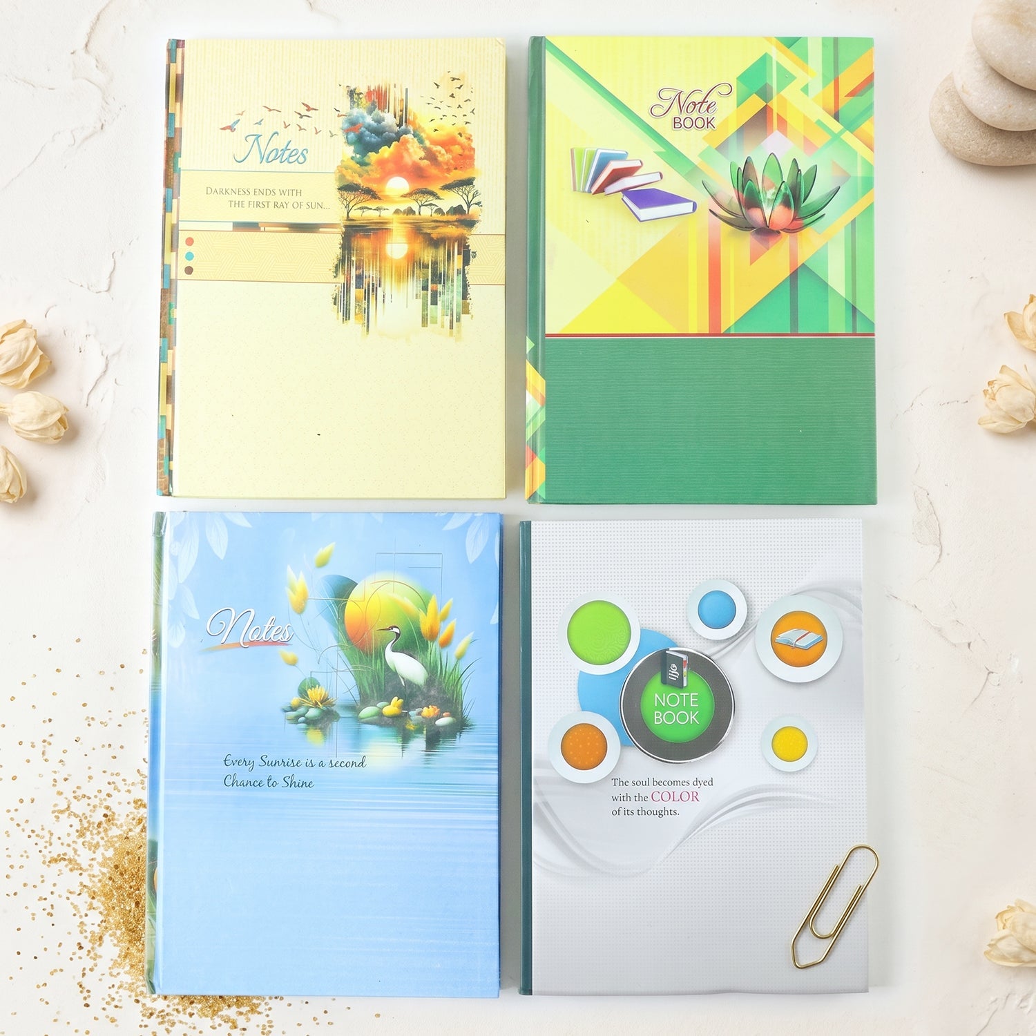 Set of four hardbound notebooks with illustrated covers in blue, green, and yellow