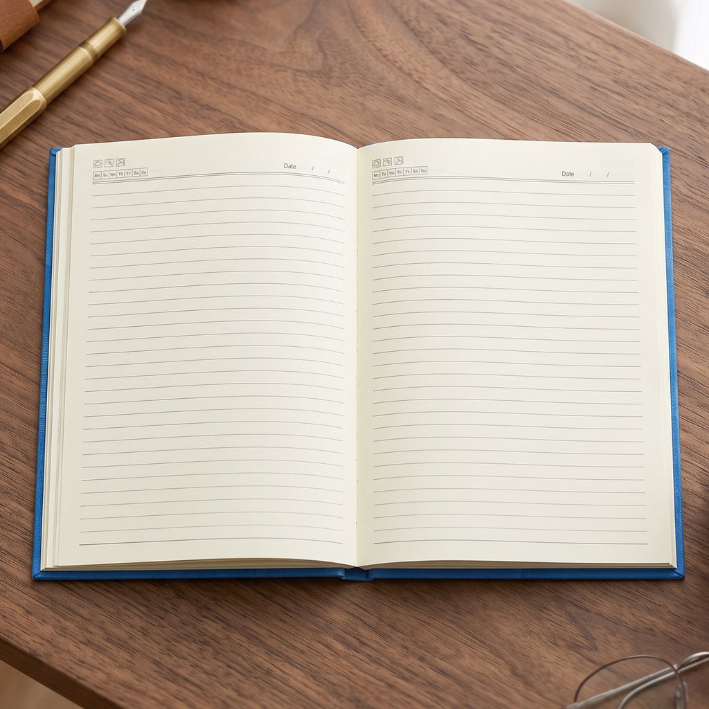 Hardbound ruled diary open showing blank lined pages and blue edge