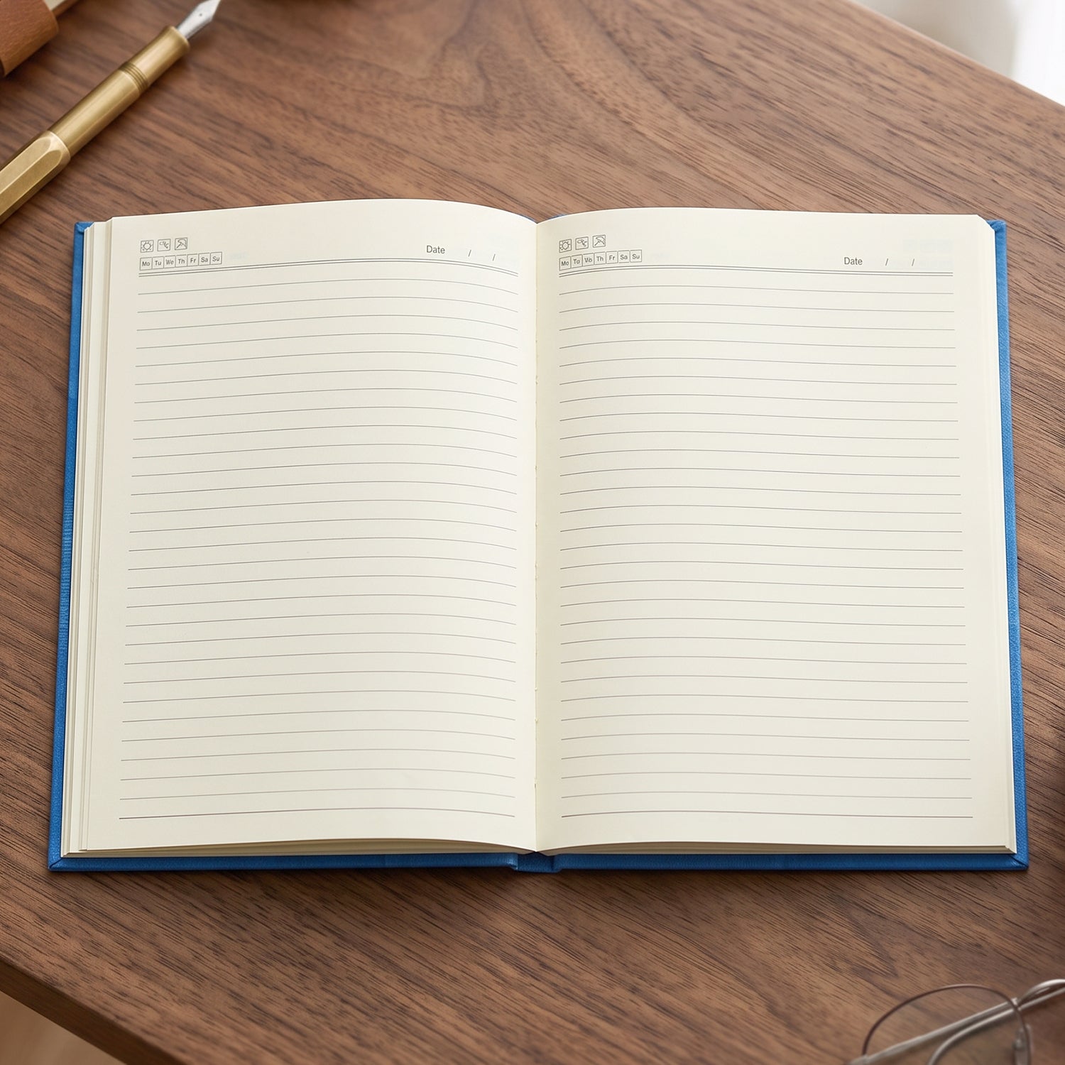 Hardbound ruled diary open showing blank lined pages and blue edge