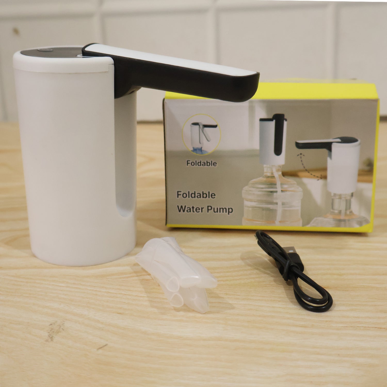 White water dispenser pump with spout, includes accessories and retail box on table