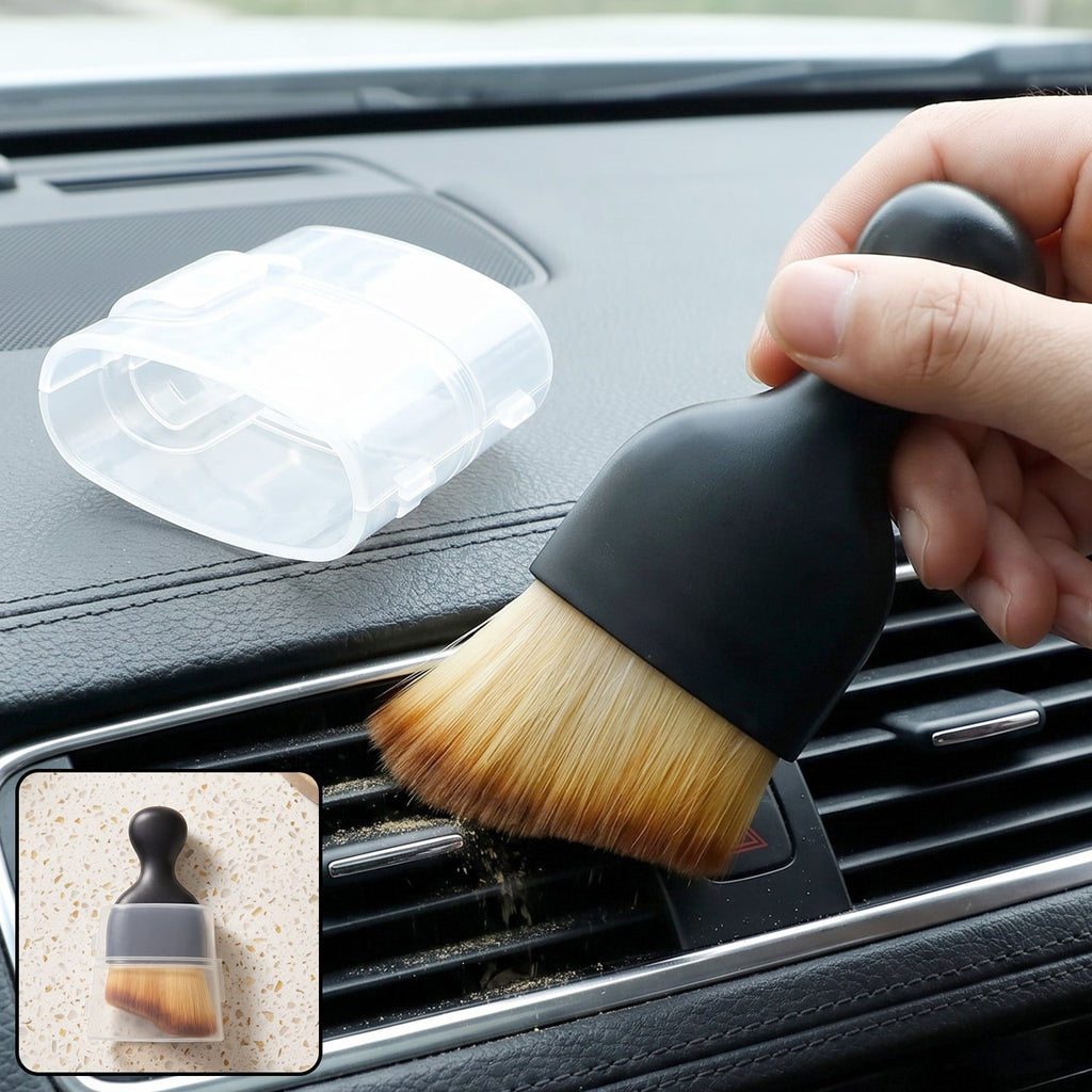 Mini car interior cleaning brush with black handle and soft tan bristles in hand