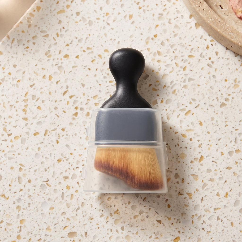 Mini cleaning brush with black handle and tan bristles in clear protective cover