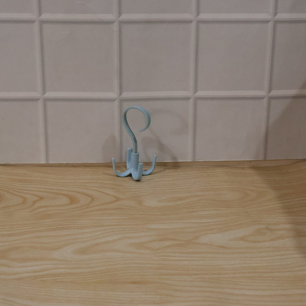 Small light blue 360° rotating hook hanger with three prongs, freestanding