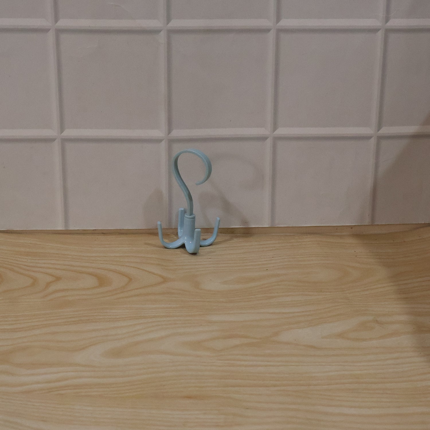 Small light blue 360° rotating hook hanger with three prongs, freestanding