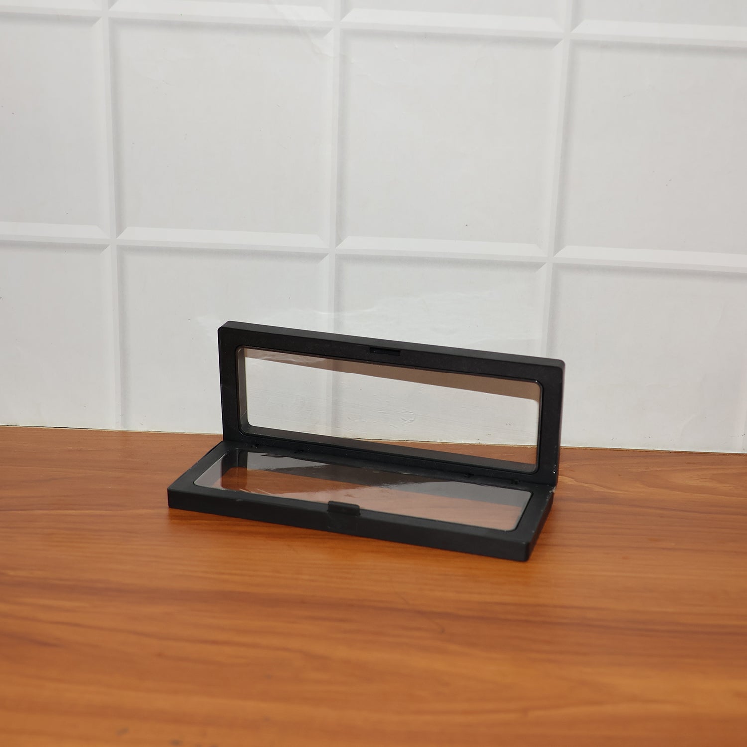 Back view of transparent floating jewelry display box showcasing sleek black ABS plastic frame