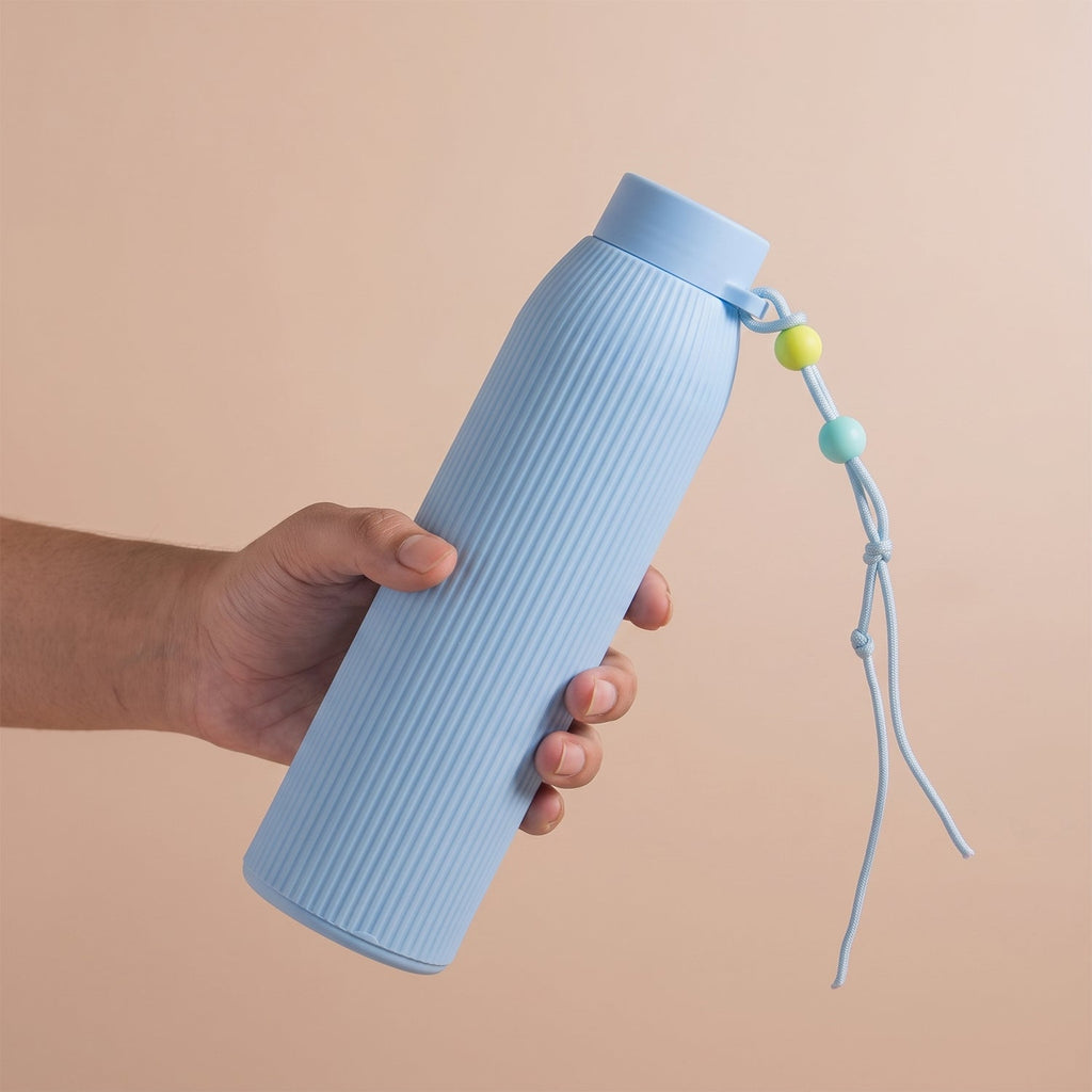 Light blue ribbed glass water bottle with silicone lid and beaded carry cord