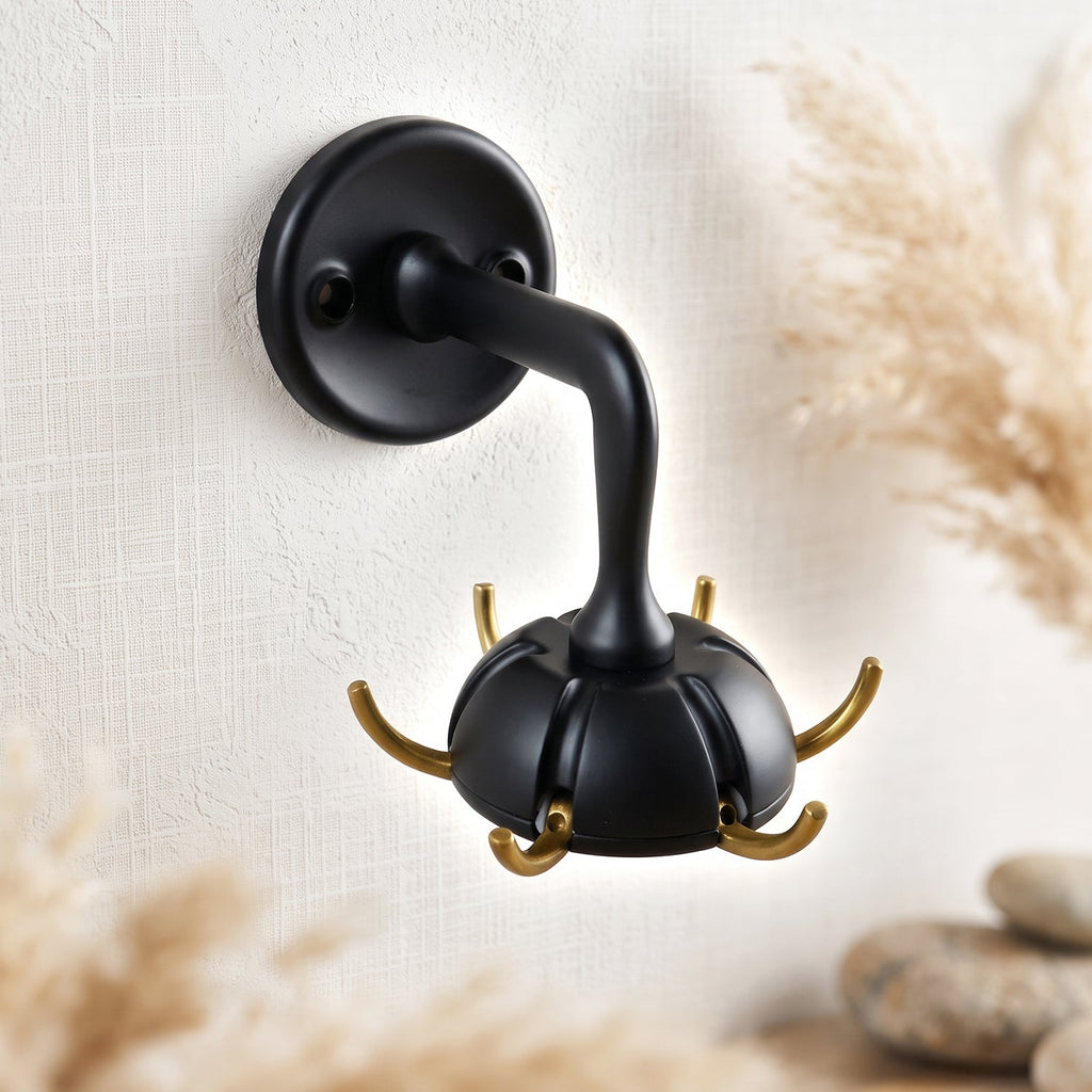 Black wall mounted multi hook with four arms and gold accent trim