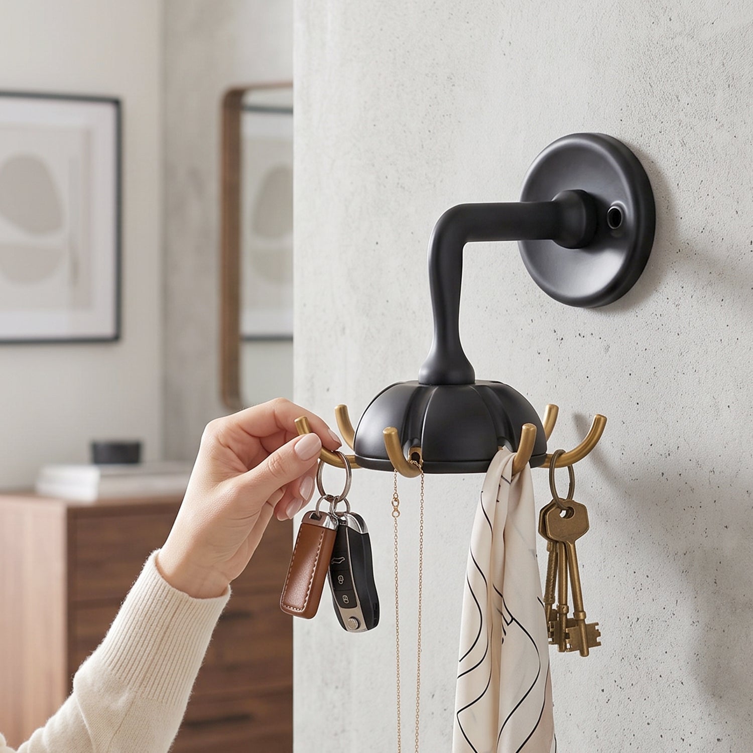 Black wall hook with multiple arms for keys and bags, gold accents on trim