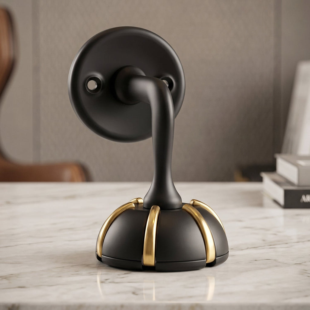 Black round base wall hook with curved handle and gold accent bands