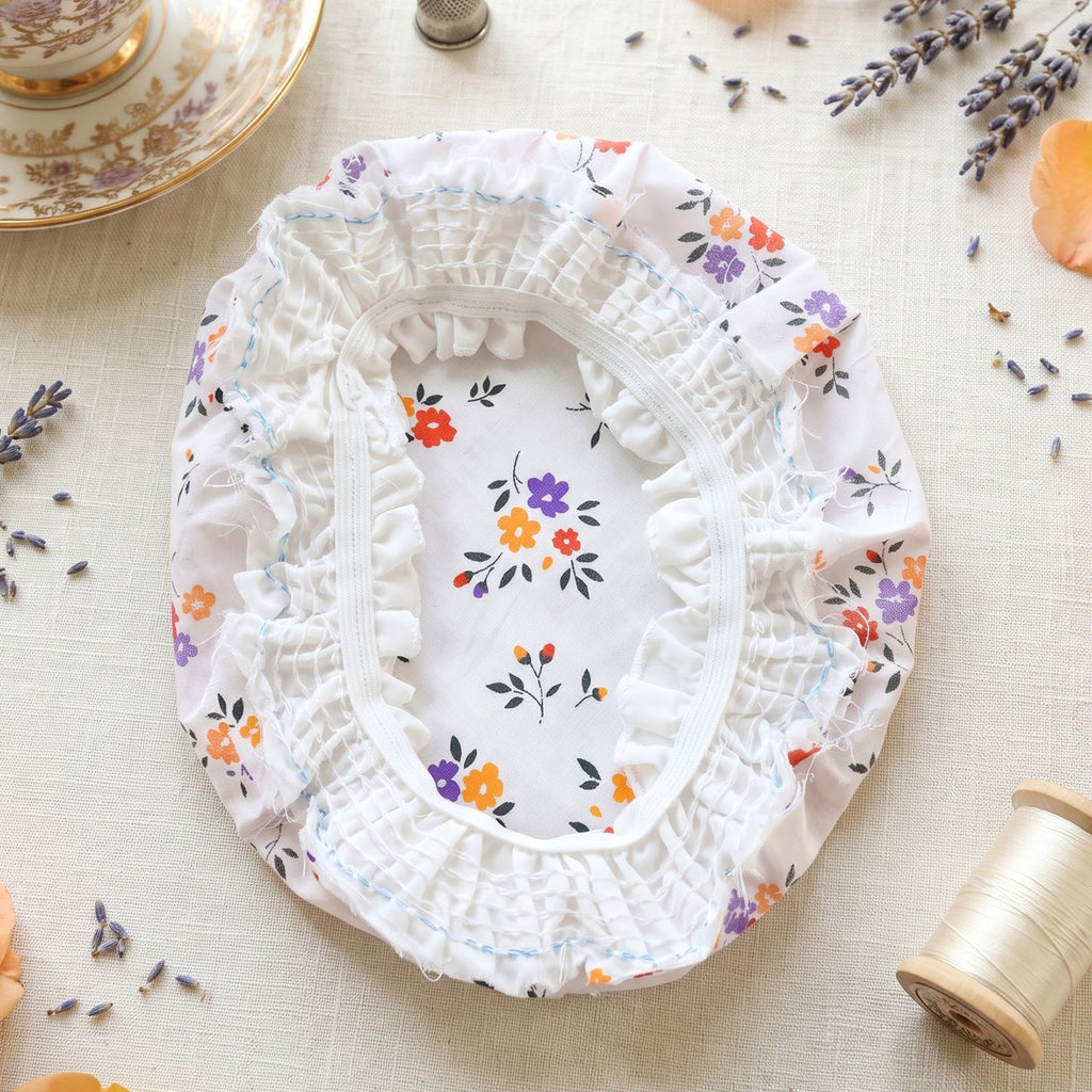 Cotton matka cover close-up, gathered white fabric with floral pattern