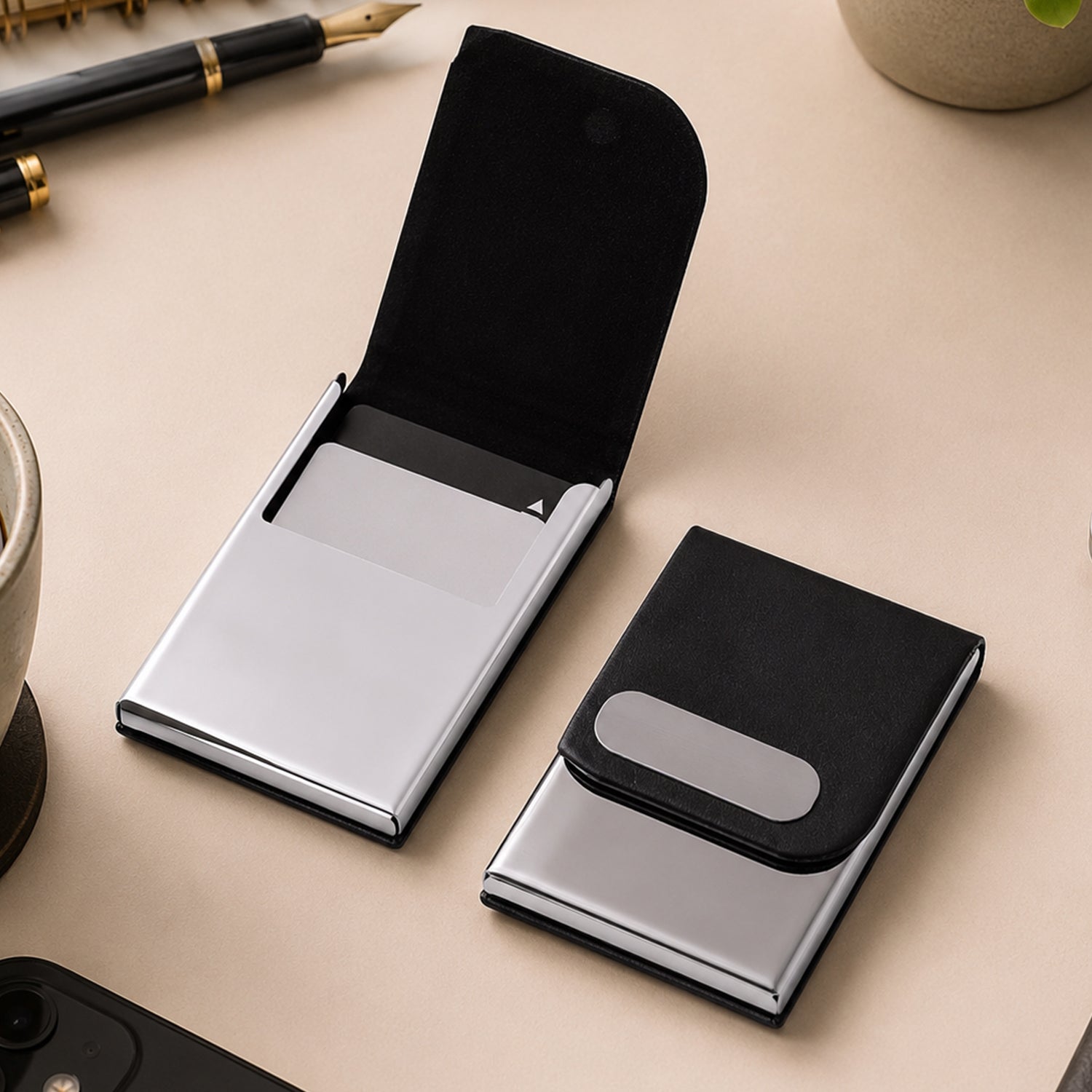 Black leather business card holder with oval slot, open and closed views