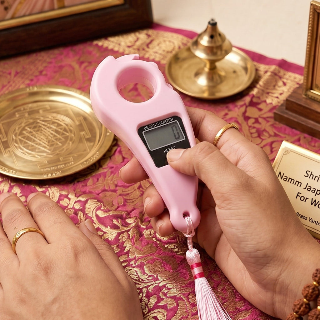 Pink finger ring digital beads counter in use with LCD screen and hanging tassel