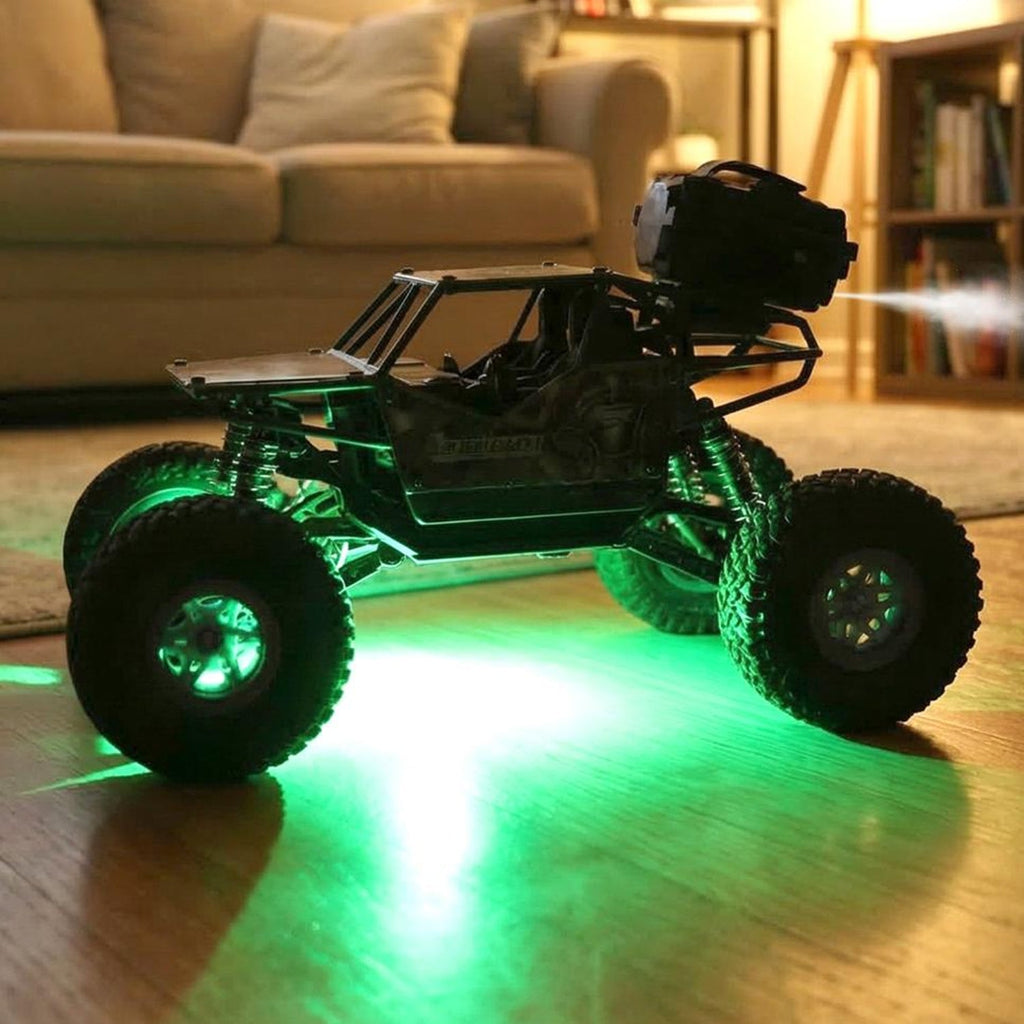 Remote-control rock crawler toy truck with green-lit LED lights and large off-road tires.