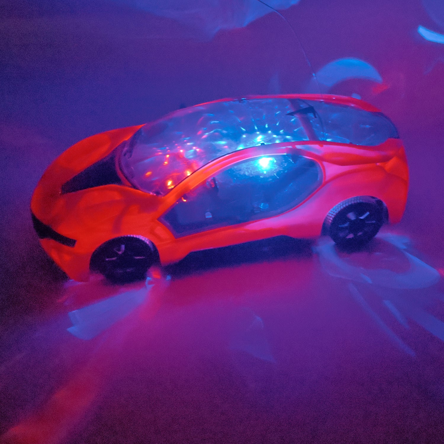 Red remote control car with glowing multicolor LED lights under purple lighting