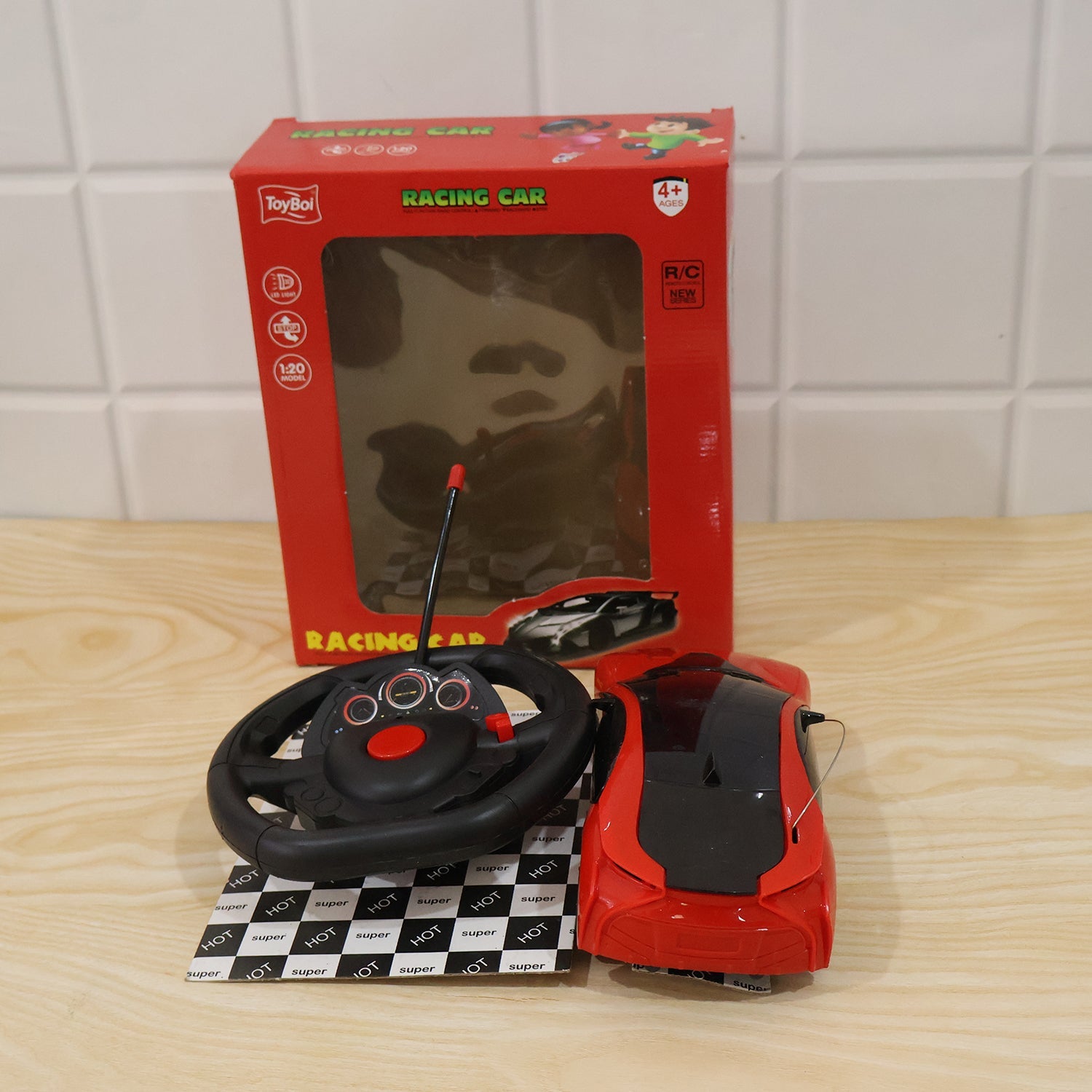 Red remote control racing car toy set with steering controller in retail packaging