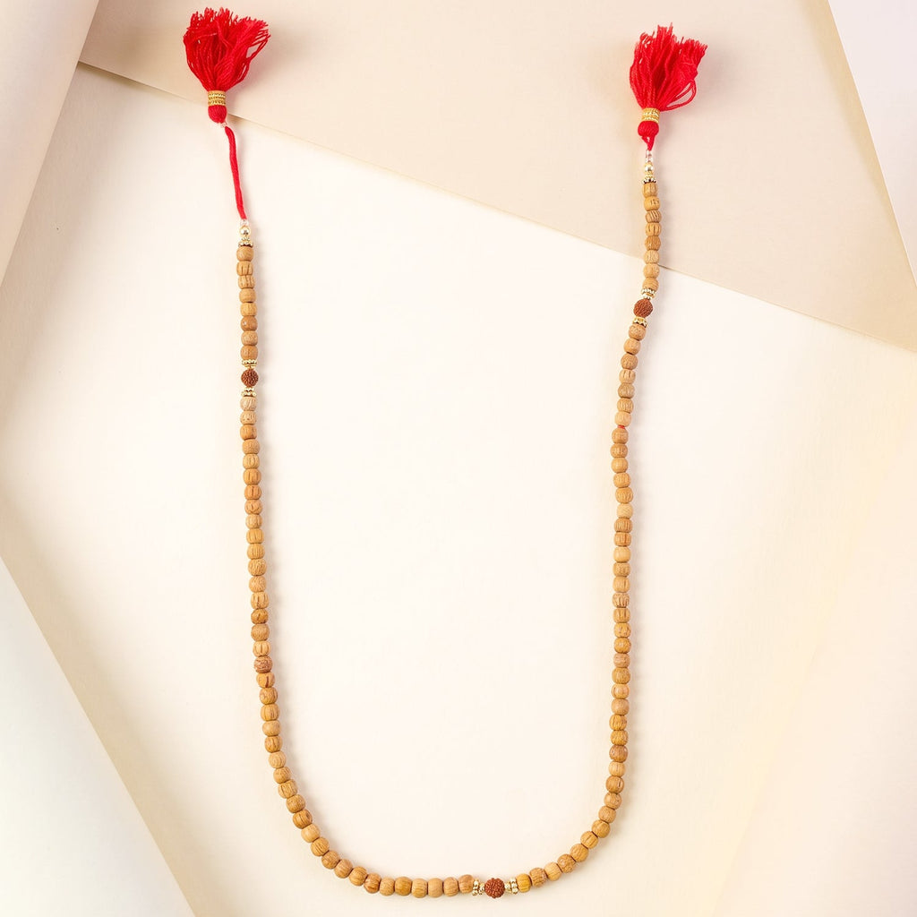 Sandalwood japa mala with light wood beads and bright red tassels on both ends