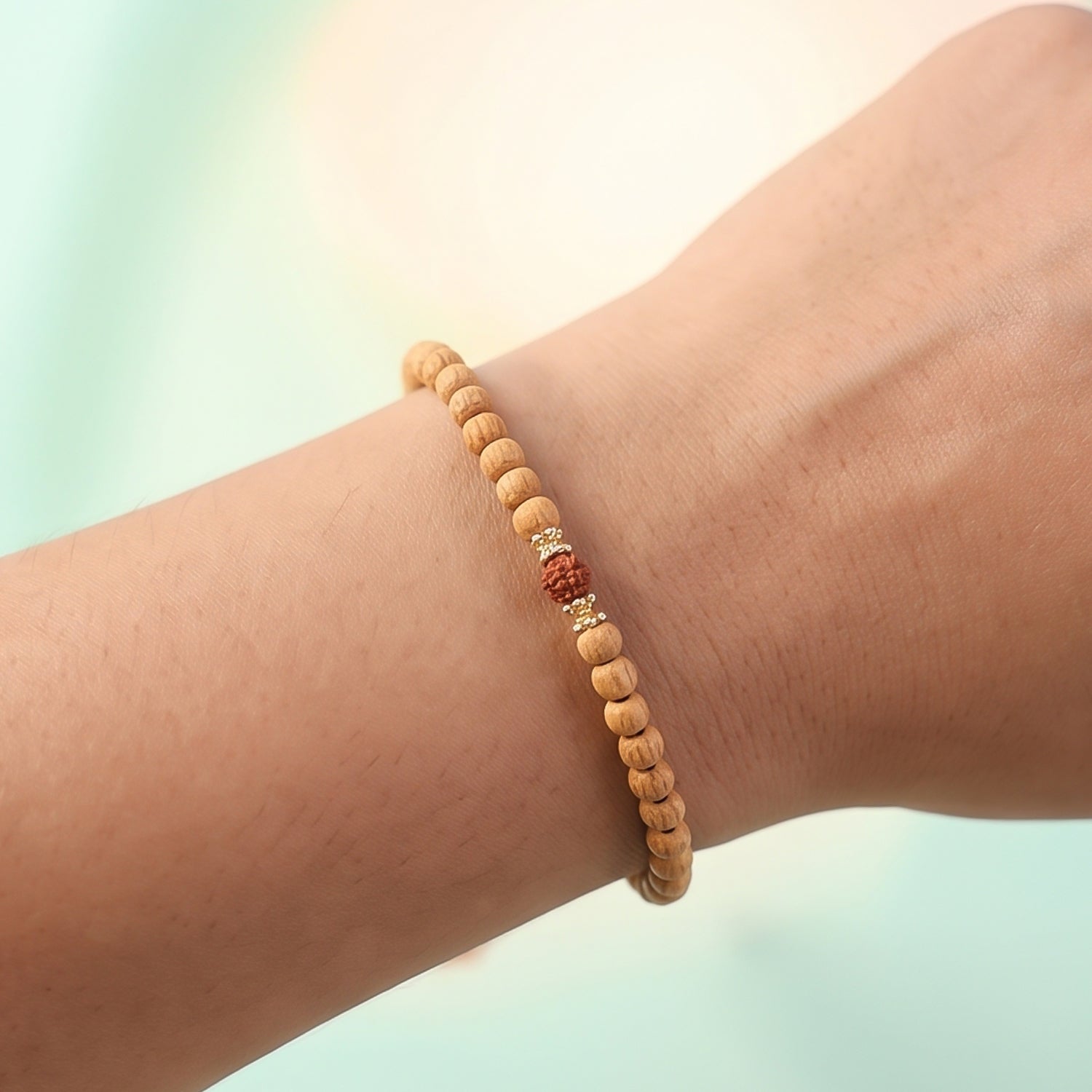 Sandalwood mala bracelet with light wood beads and a small red bead detail