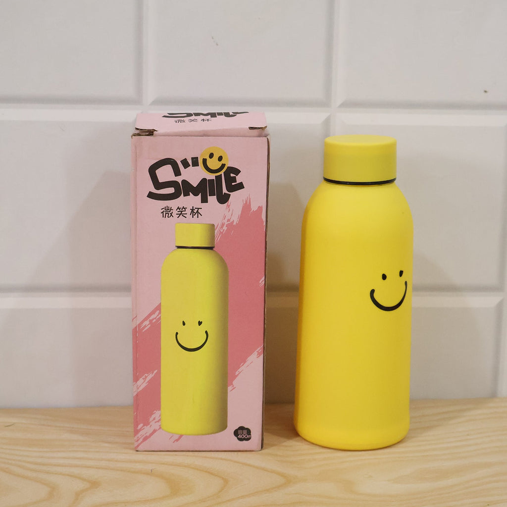 Yellow glass water bottle with silicone sleeve and smiley face, with retail box