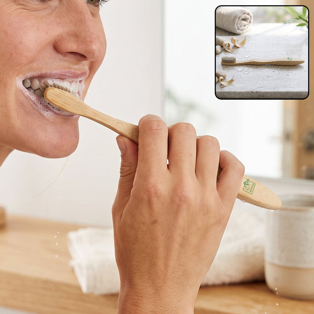 Bamboo toothbrush with soft bristles, held at an angle during brushing