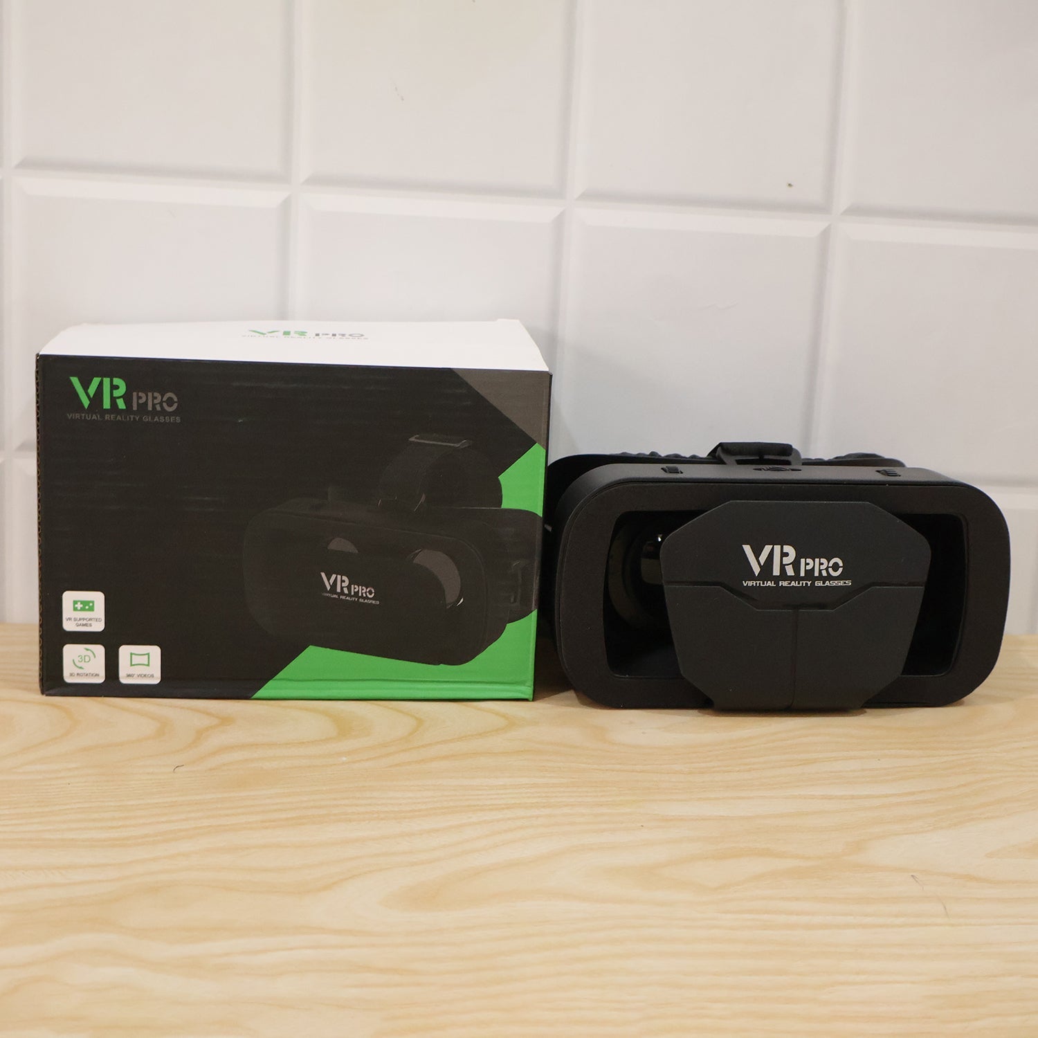 Black VR Pro VR headset with product box, front view on a wooden surface