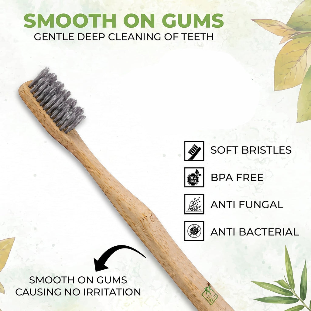 Bamboo toothbrush with soft gray bristles on wooden handle, angled view